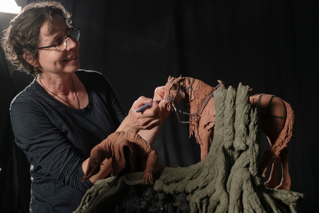 Artist Brigitte Wuest working on Masters Collection sculpture of a horse